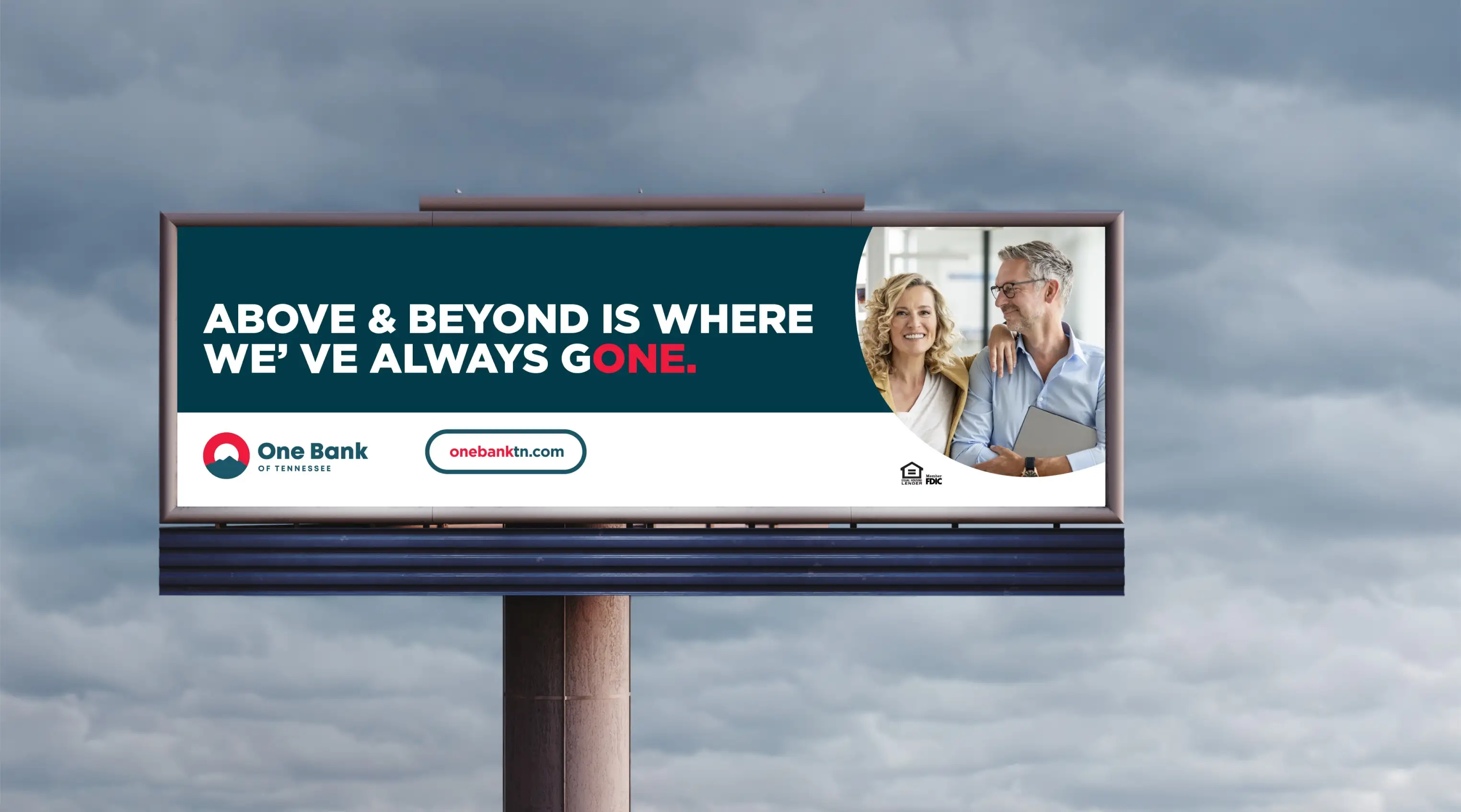 A One Bank of Tennessee outdoor advertisement that says 'The do it all from your phone bank.' accomponied by a woman smiling while using her phone